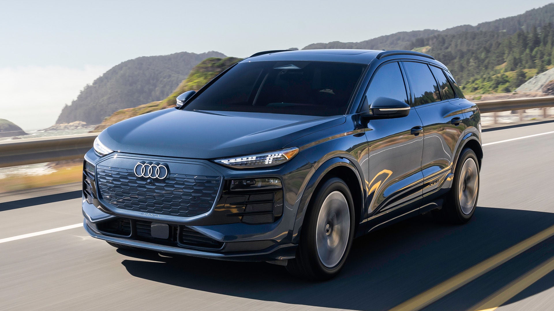 Right profile view of an Audi Q6 etron accelerating.